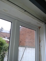 French doors surround with water damage after mastic joints failed on the outside of the door frame
