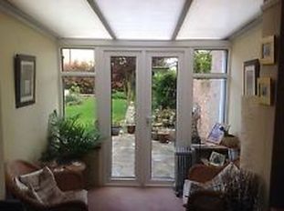Conservatory entrance with clear glass units after we replaced them at a fraction of new doors and windows.